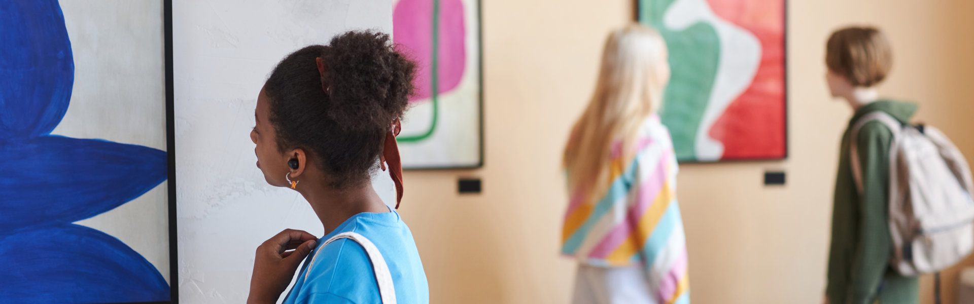 people looking at the paintings